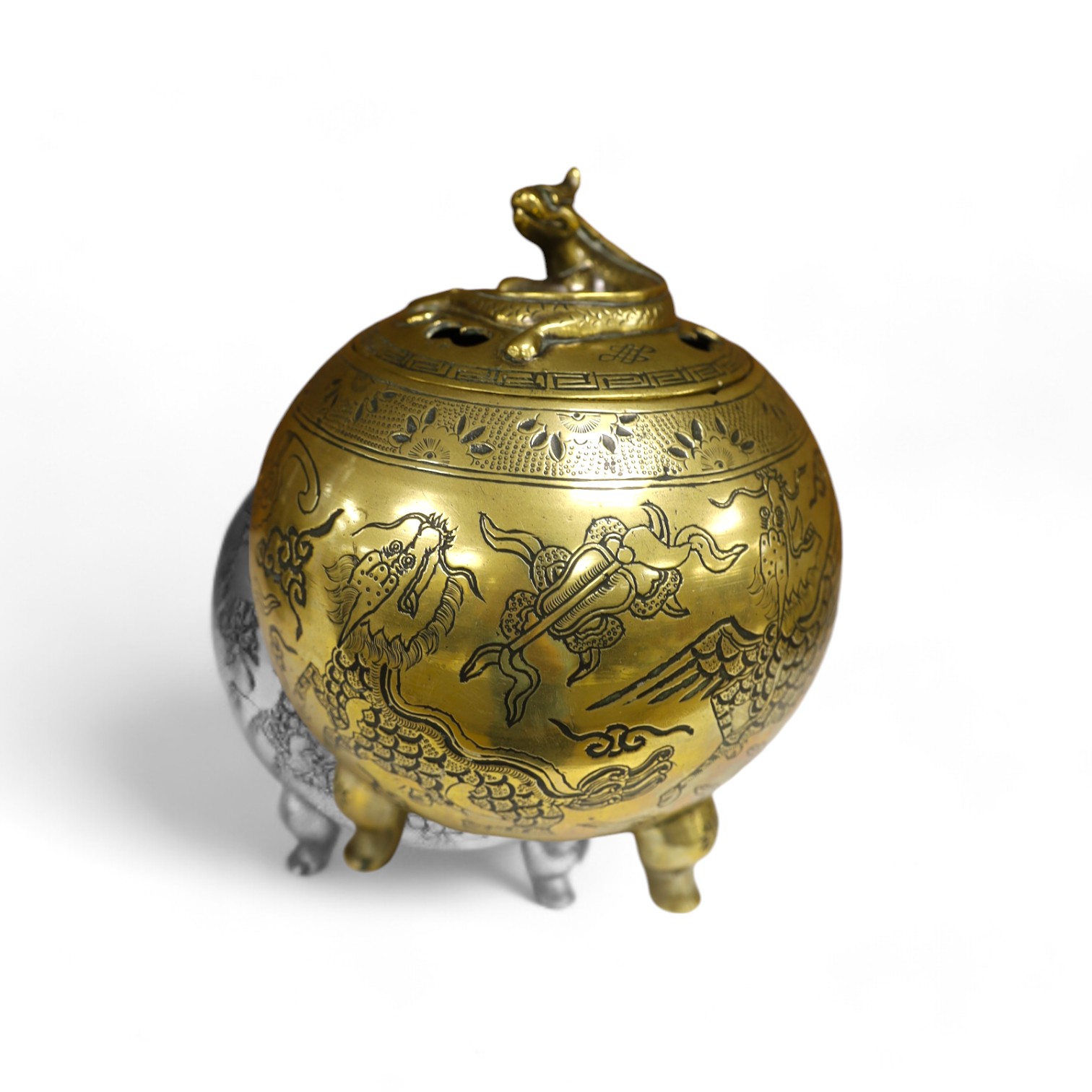 A Chinese bronze globular dragon decorated censer and cover on three legs, Xuande mark, early 20th century, 20cm high. Condition - good